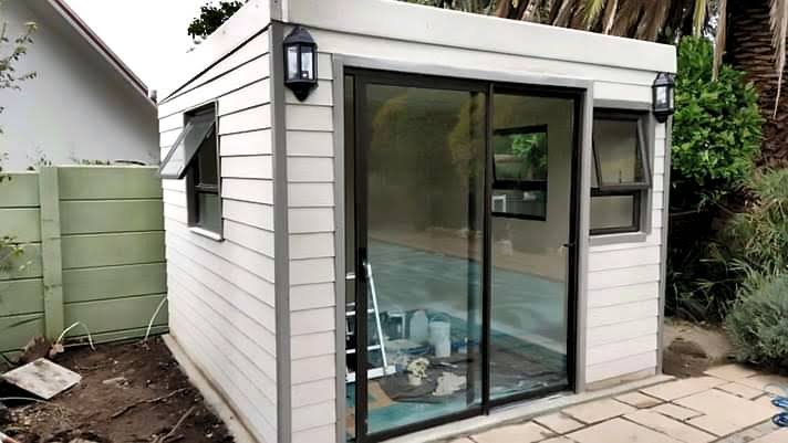 Compact white house with large glass sliding doors